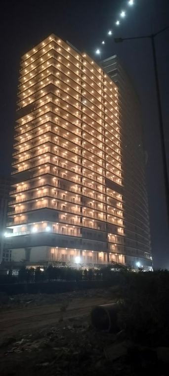 F Premiere Tower B, finished with balconies lit at night, Kharghar, Navi Mumbai